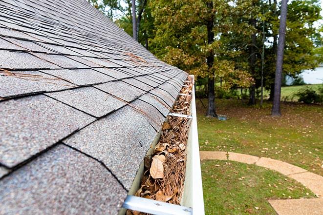 cleaning out gutters to prevent water damage